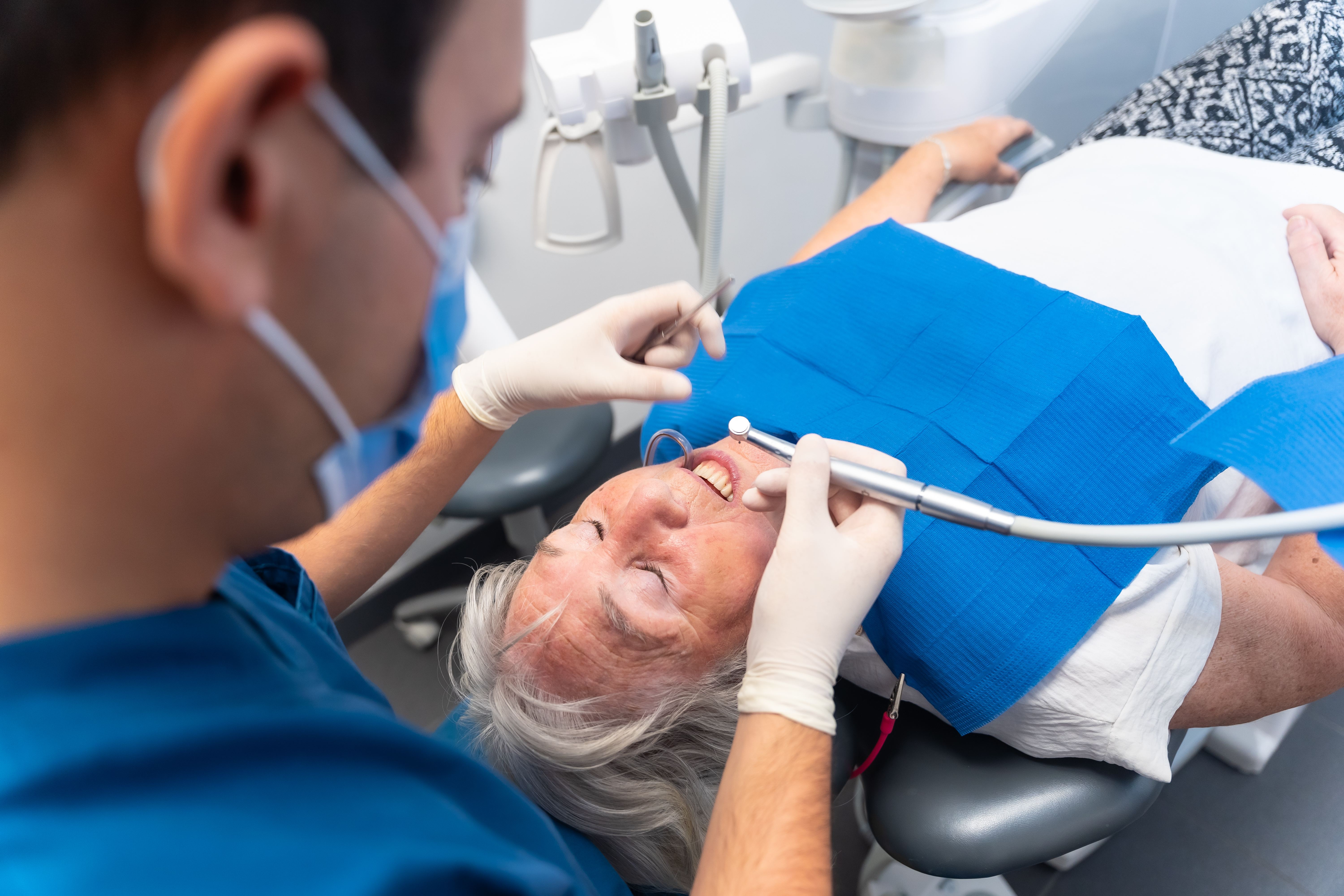 Dental clinic elderly woman at dentist with doctor on routine denture checkup