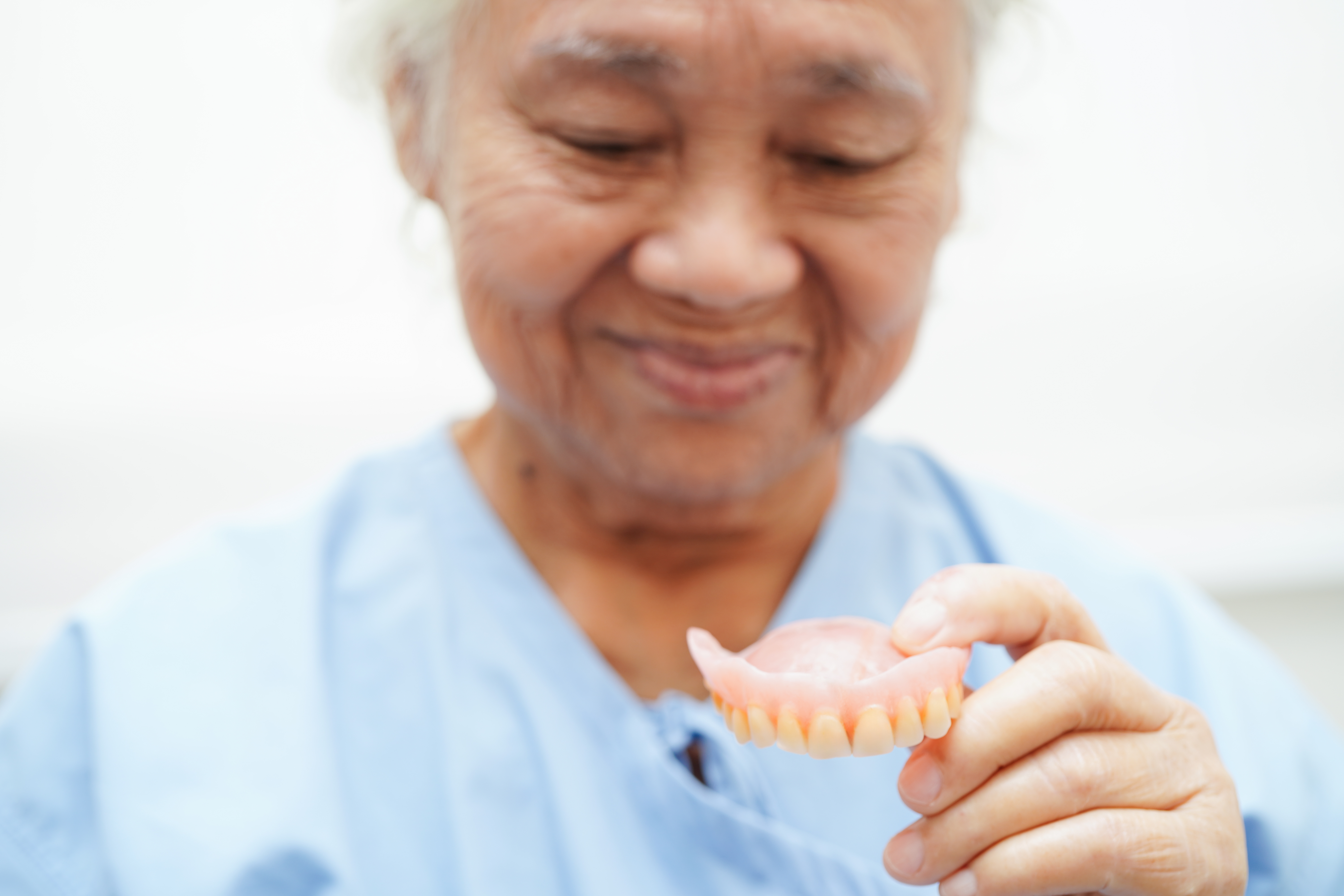 Doctor holding teeth denture in hand for dentist studying about dentistry